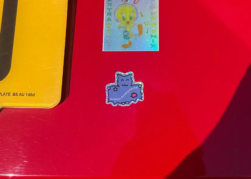 glittery bat sticker on a red car.